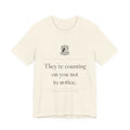 They're Counting On You Not to Notice — Watchdog Tee (Natural)