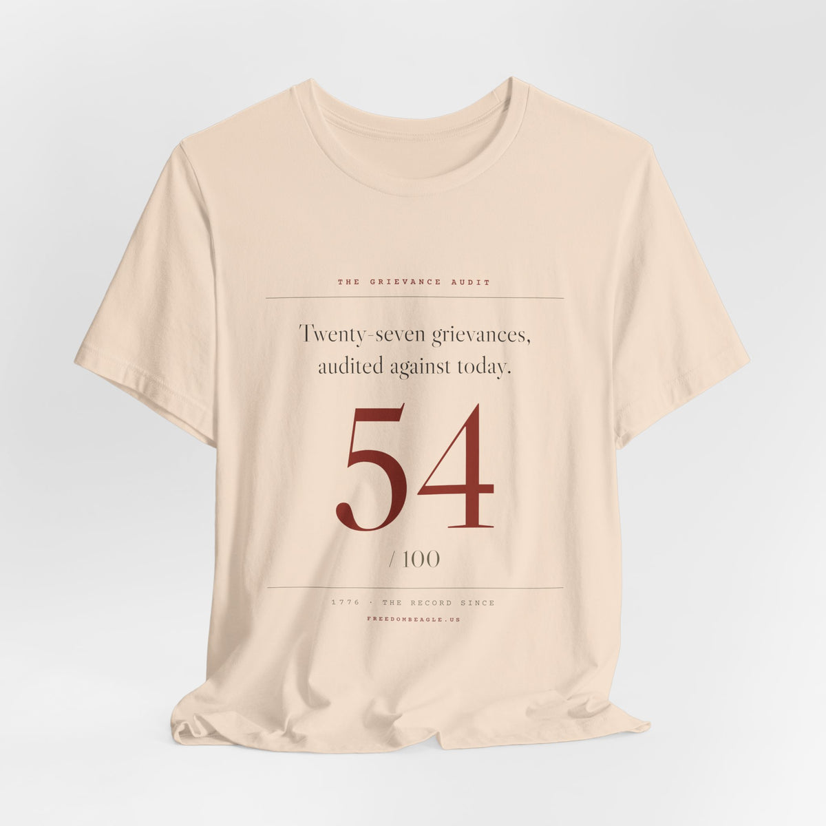 Twenty-Seven Grievances, Audited. It Got a 54. — Scorecard Tee (Natural)